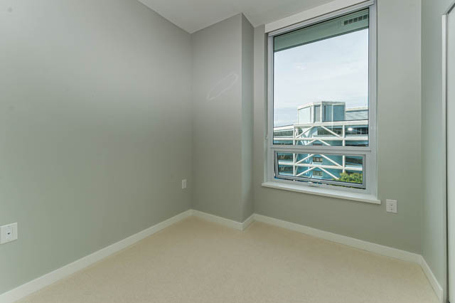 Bright living room with large windows and city view. - 802 - 118 Carrie Cates Court, North Vancouver