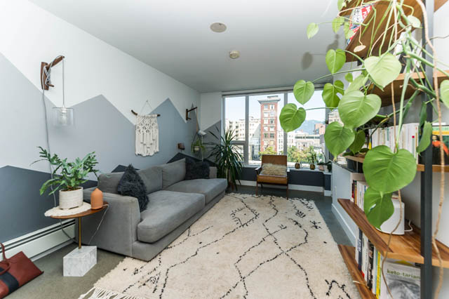 Furnished 1-bedroom + den with city view, modern decor, and hanging plants. - 501 - 231 E Pender Street, Vancouver Downtown