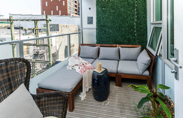Furnished balcony with outdoor seating, green wall, and city view. - 501 - 231 E Pender Street, Vancouver Downtown