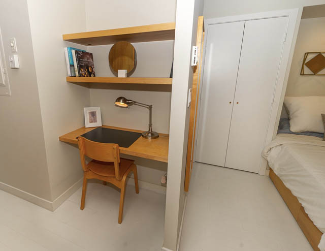 Bright and cozy loft with wooden desk, bookshelf, and neatly made bed. - 410 - 1072 Hamilton St, Vancouver Downtown