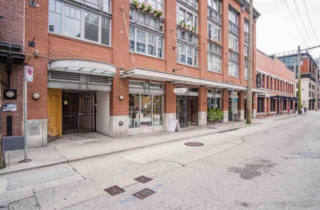 Loft with brick facade, large windows, and modern furnishings. - 410 - 1072 Hamilton St, Vancouver Downtown