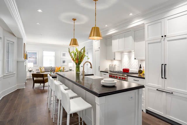 Bright kitchen with white cabinetry, hardwood floors, and a city view. - 201 - 1785 W 16th Avenue, Vancouver West Side