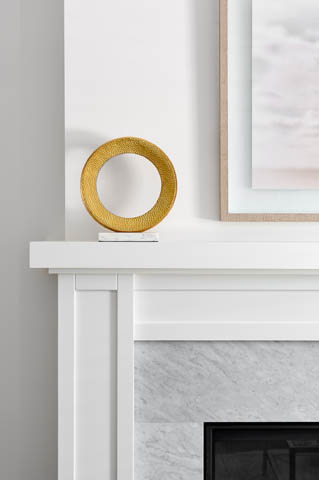 Living room with white fireplace mantel, gold circular decor, and framed artwork. - 201 - 1785 W 16th Avenue, Vancouver West Side