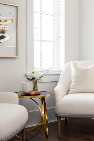 Bright living room with modern furniture, gold accents, and large window view. - 201 - 1785 W 16th Avenue, Vancouver West Side