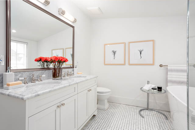Bright bathroom with white marble countertops and framed botanical prints. - 201 - 1785 W 16th Avenue, Vancouver West Side