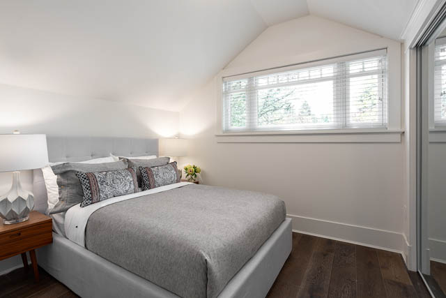 Bright bedroom with vaulted ceiling, large window, and cozy bedding. - 201 - 1785 W 16th Avenue, Vancouver West Side