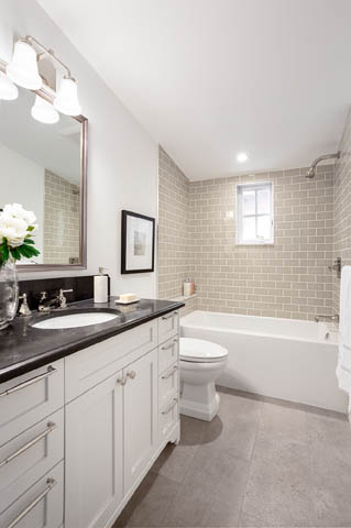 Bright bathroom with white vanity, black countertop, and gray subway tile walls. - 201 - 1785 W 16th Avenue, Vancouver West Side