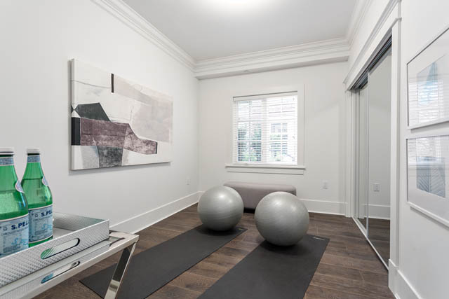 Bright living room with modern artwork, hardwood floors, and a city view. - 201 - 1785 W 16th Avenue, Vancouver West Side