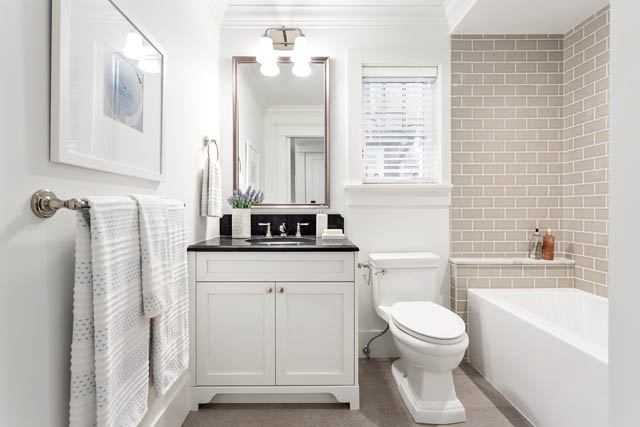 Furnished bathroom with white cabinets, subway tile backsplash, and modern fixtures. - 201 - 1785 W 16th Avenue, Vancouver West Side