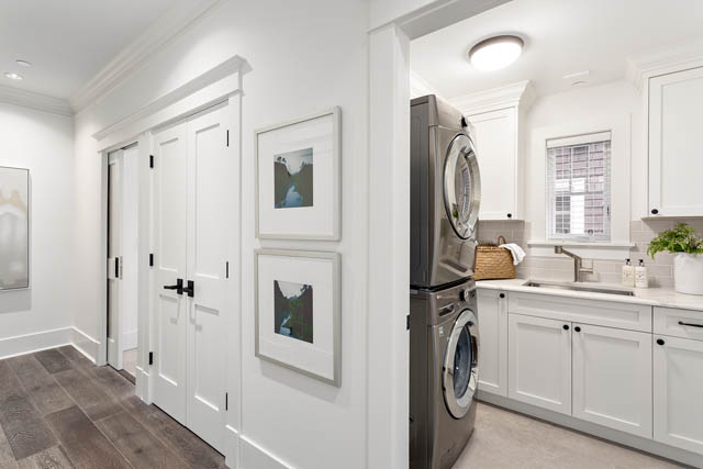 Bright laundry room with white cabinets, stainless steel appliances, and hardwood floors. - 201 - 1785 W 16th Avenue, Vancouver West Side