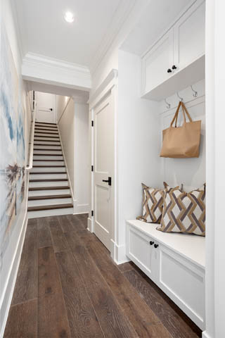 Foyer with hardwood floors, white cabinets, and a bench with pillows. - 201 - 1785 W 16th Avenue, Vancouver West Side