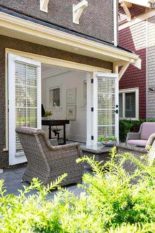 Furnished patio with wicker furniture and open sliding glass doors leading to a cozy interior. - 201 - 1785 W 16th Avenue, Vancouver West Side