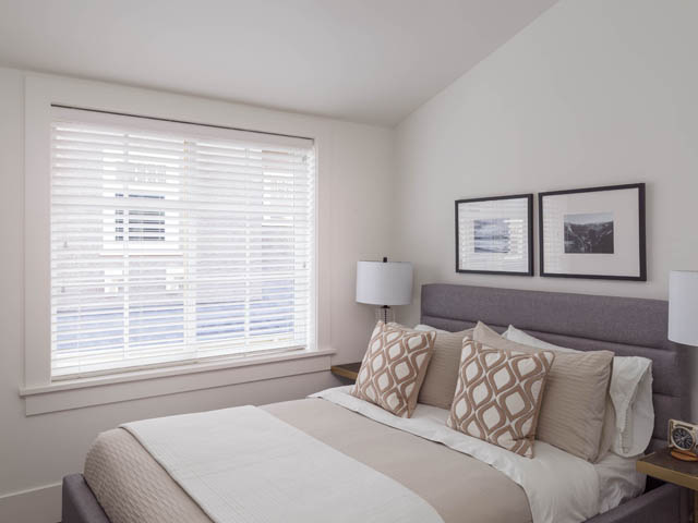 Spacious bedroom with large window, modern decor, and city view. - 3170 Burrard St, Vancouver West Side