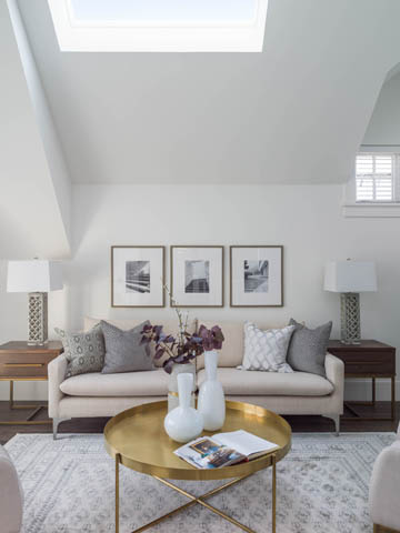 Bright living room with skylight, white walls, and a beige sofa. - 3170 Burrard St, Vancouver West Side
