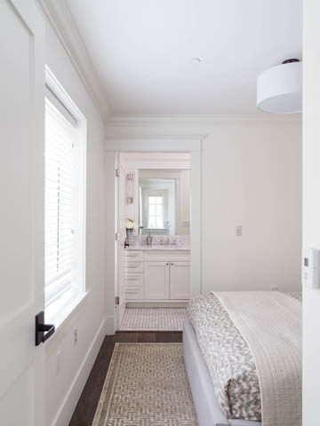 Bright bedroom with white walls, wooden floors, and a large window. - 3170 Burrard St, Vancouver West Side