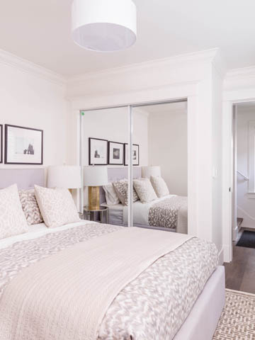 Spacious bedroom with mirrored closet doors and soft bedding. - 3170 Burrard St, Vancouver West Side