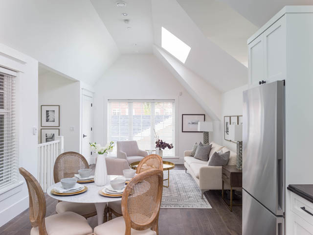 Bright dining area with hardwood floors and a skylight, featuring a round table and wicker chairs. - 3170 Burrard St, Vancouver West Side