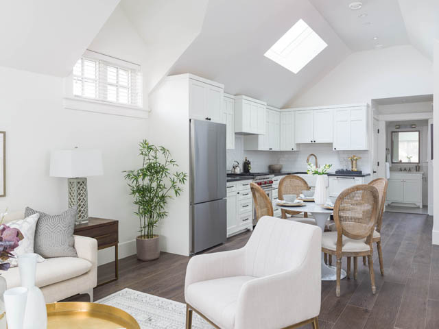Bright kitchen with white cabinetry, hardwood floors, and a skylight. - 3170 Burrard St, Vancouver West Side