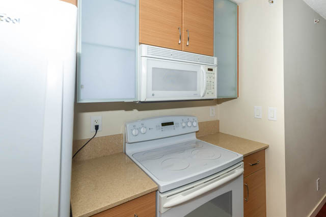 Bright kitchen with light wood cabinets, white appliances, and granite countertops. - 1602 - 977 Mainland Street, Vancouver Downtown