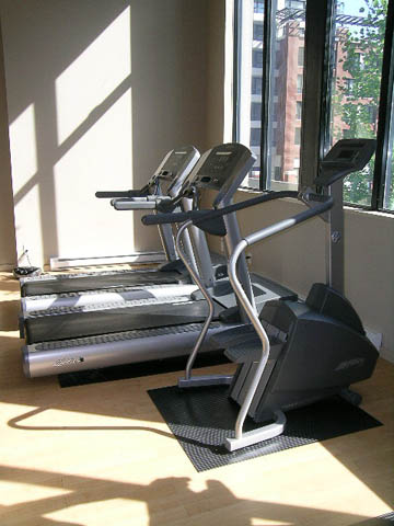 Fitness room with treadmills and ellipticals, hardwood floors, city view. - 1602 - 977 Mainland Street, Vancouver Downtown