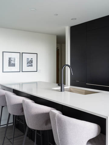 Bright kitchen with sleek black cabinets, white countertops, and modern bar stools. - 805 -  210 E 5th Avenue, Vancouver East Side