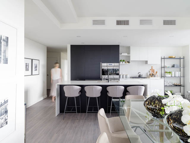 Bright kitchen with dark countertops and white cabinets, hardwood floors, and a city view. - 805 -  210 E 5th Avenue, Vancouver East Side