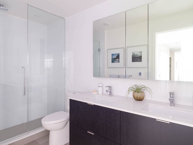 Bright bathroom with modern vanity, large mirror, and glass shower. - 805 -  210 E 5th Avenue, Vancouver East Side