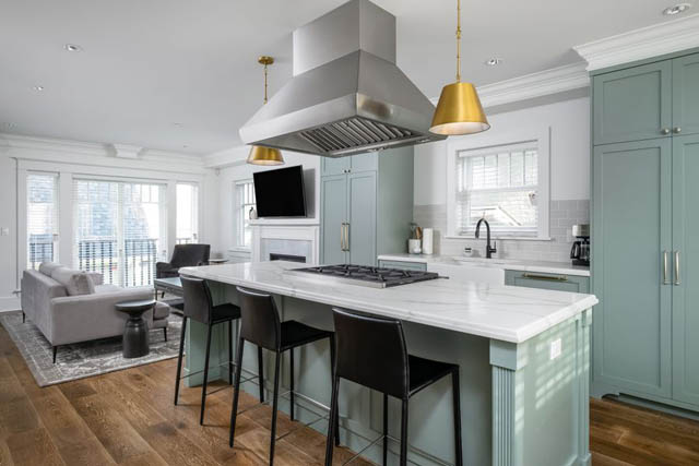 Bright kitchen with light green cabinets, white countertops, and hardwood floors. - 200 - 1775 W 16th Avenue, Vancouver West Side