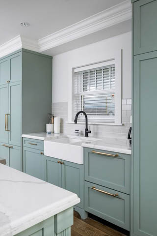 Bright kitchen with light blue cabinets, white marble countertops, and a farmhouse sink. - 200 - 1775 W 16th Avenue, Vancouver West Side