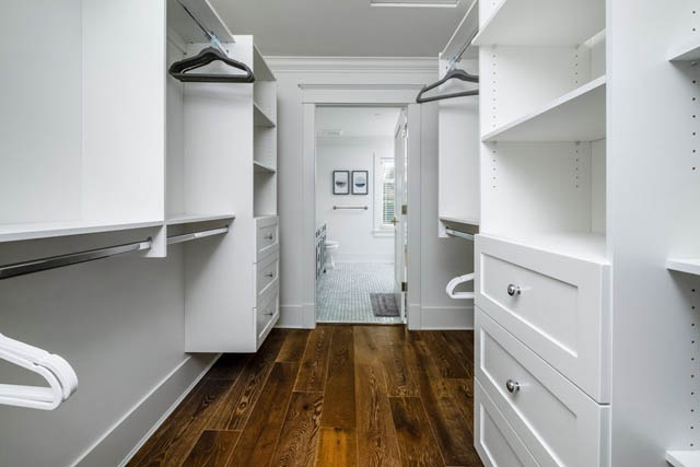 Spacious walk-in closet with white shelves and hardwood floors. - 200 - 1775 W 16th Avenue, Vancouver West Side
