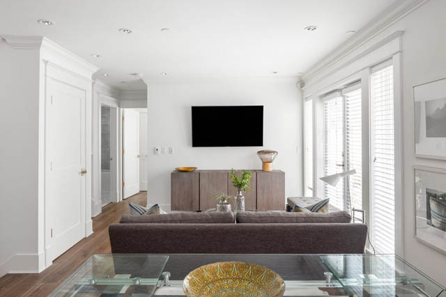 Bright living room with hardwood floors, modern furniture, and a large window with blinds. - 	1783 W 16th Ave, Vancouver West Side