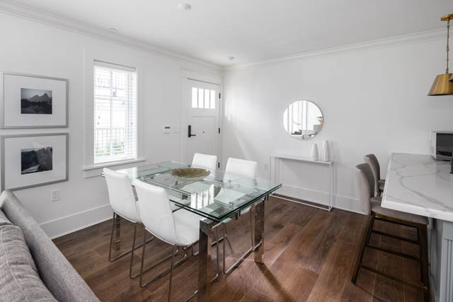 Bright dining area with glass table, white chairs, and marble countertop. - 	1783 W 16th Ave, Vancouver West Side