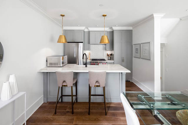Bright kitchen with white marble countertops and hardwood floors. - 	1783 W 16th Ave, Vancouver West Side