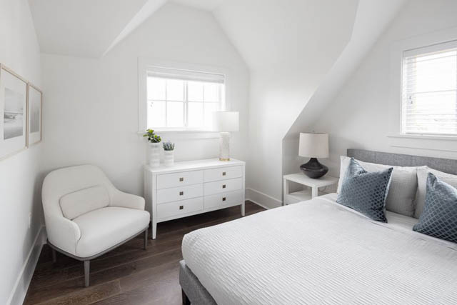 Bright bedroom with white walls, wooden floors, and a cozy bed setup. - 	1783 W 16th Ave, Vancouver West Side