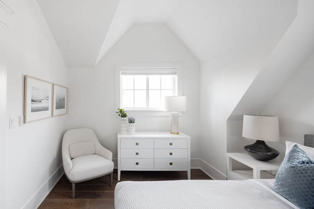 Bright bedroom with white walls, hardwood floors, and a cozy bed setup. - 	1783 W 16th Ave, Vancouver West Side