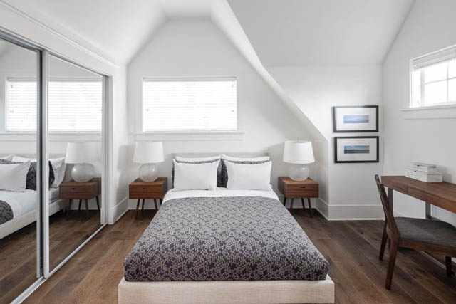 Bright bedroom with hardwood floors and a large closet, featuring a cozy bed and a desk area. - 	1783 W 16th Ave, Vancouver West Side