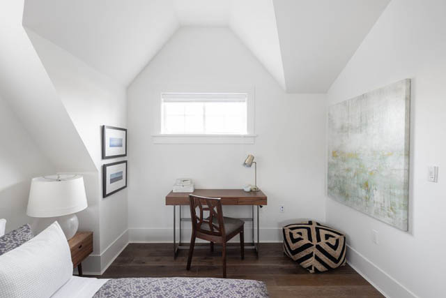Bright attic bedroom with sloped ceiling, wooden desk, and abstract wall art. - 	1783 W 16th Ave, Vancouver West Side