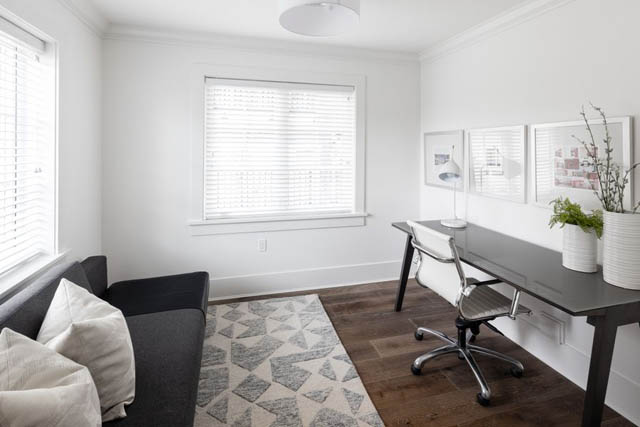 Bright living room with white walls, geometric rug, and modern furniture. - 	1783 W 16th Ave, Vancouver West Side
