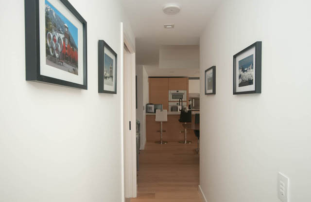 Bright hallway leading to kitchen with modern appliances and wooden floors. - 1803 - 620 Cardero Street, Vancouver Downtown