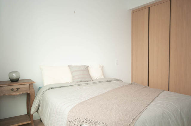 Spacious bedroom with wooden wardrobe and neatly made bed. - 1803 - 620 Cardero Street, Vancouver Downtown