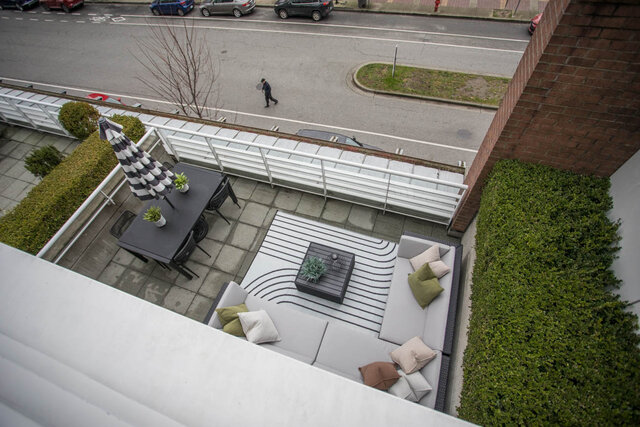 Spacious rooftop patio with outdoor seating, greenery, and a city view. - THA - 1199 Marinaside Cres, Vancouver Downtown