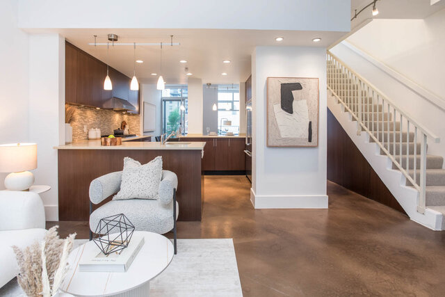 Modern open-concept living with sleek countertops, hardwood floors, and a city view. - THA - 1199 Marinaside Cres, Vancouver Downtown