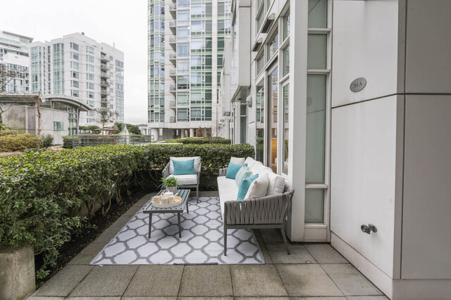 Furnished patio with modern furniture, greenery, and city views. - THA - 1199 Marinaside Cres, Vancouver Downtown
