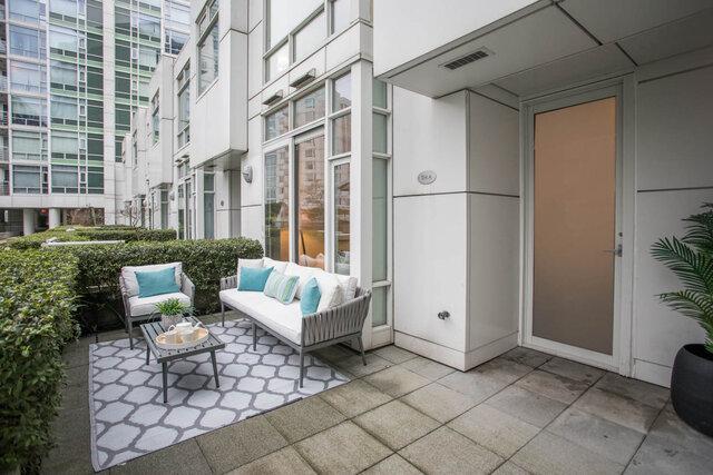 Spacious patio with modern furniture and a geometric rug, perfect for relaxation. - THA - 1199 Marinaside Cres, Vancouver Downtown