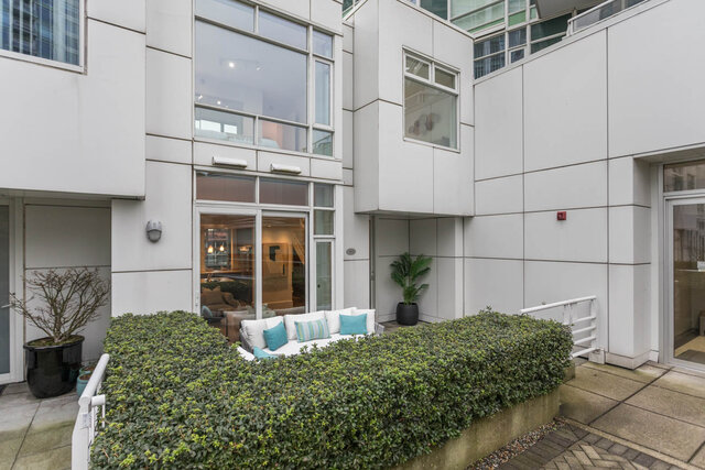 Spacious outdoor patio with modern furnishings and lush greenery, perfect for relaxing. - THA - 1199 Marinaside Cres, Vancouver Downtown