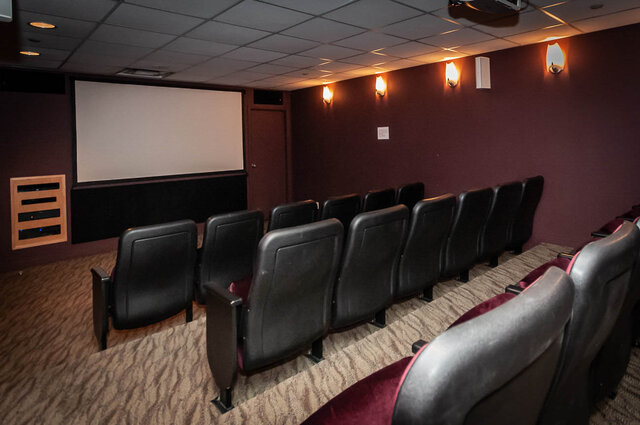 Spacious home theater with plush seating and wall-mounted lights. - THA - 1199 Marinaside Cres, Vancouver Downtown