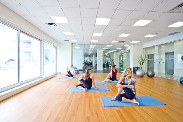 Bright and airy yoga studio with hardwood floors, large windows, and mirrored walls. - 105 - 199 Victory Ship Way, North Vancouver
