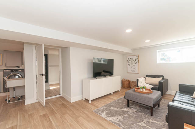 Furnished living room with hardwood floors and modern furniture. - Suite - 522 5th St E, North Vancouver