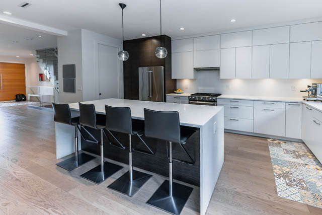 Bright kitchen with white cabinets, black barstools, and hardwood floors. - Address WITHHELD, North Vancouver