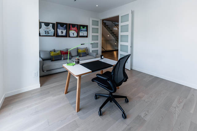 Bright living room with modern furniture, hardwood floors, and a view of the staircase. - Address WITHHELD, North Vancouver